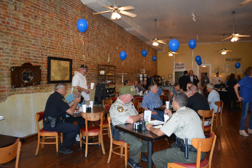 Image of several people sitting around multiple tables.
