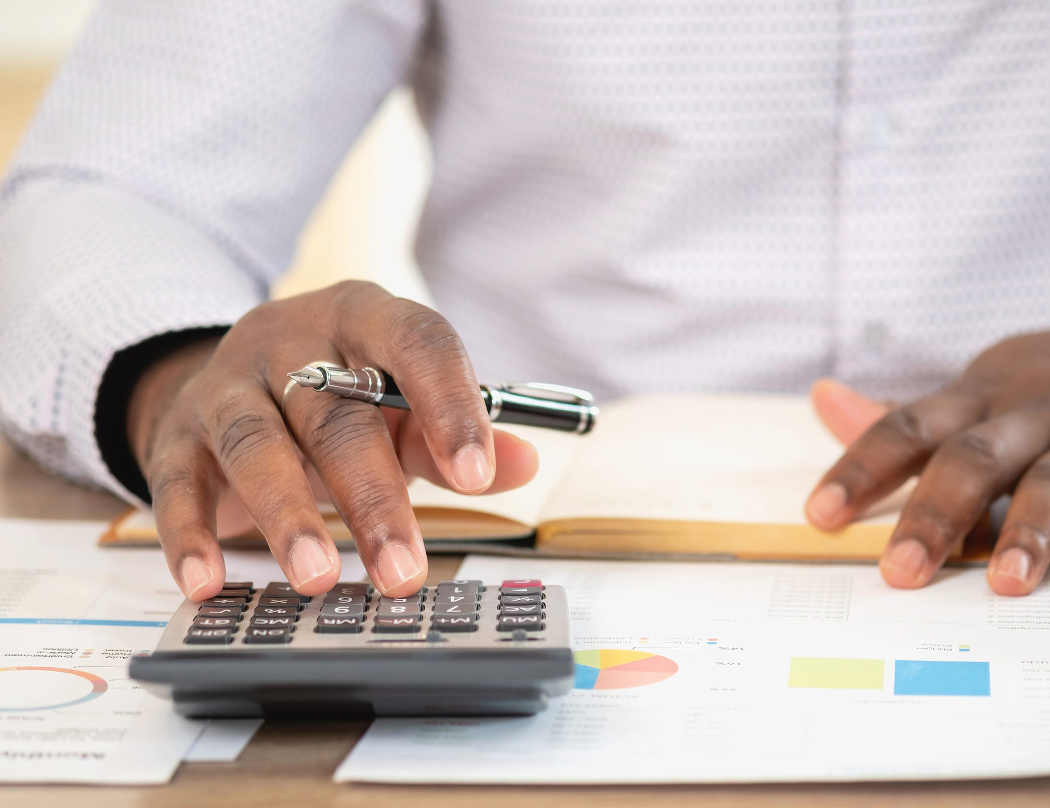 African black businessman sitting doing a financial report and studying annual profit analysis An accountant checking the financial status of the company is in the office.