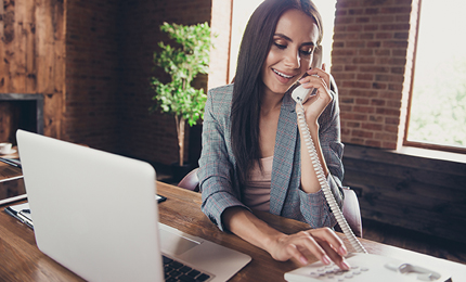 Smart, clever and intelligent agent lady in gray checkered blazer dials a phone number to contact the delivery department and send the order to customer