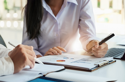 A male business consultant describes a marketing plan to set business strategies for women business owners witch using tablet. business planning and business researching concept. Planning and Investment and discuss concept.